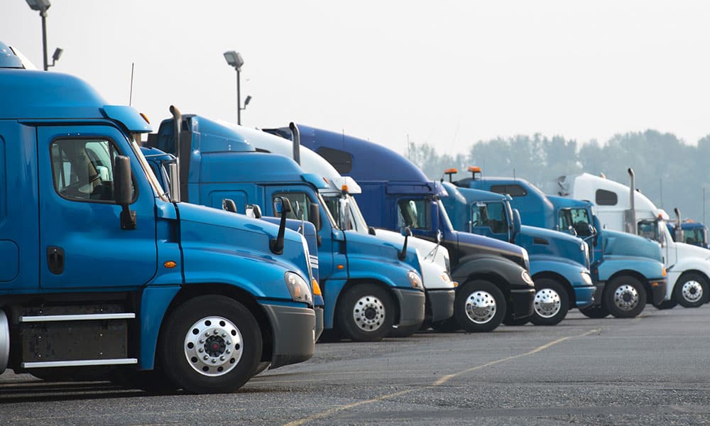 A fleet of Trucks in a parking lot